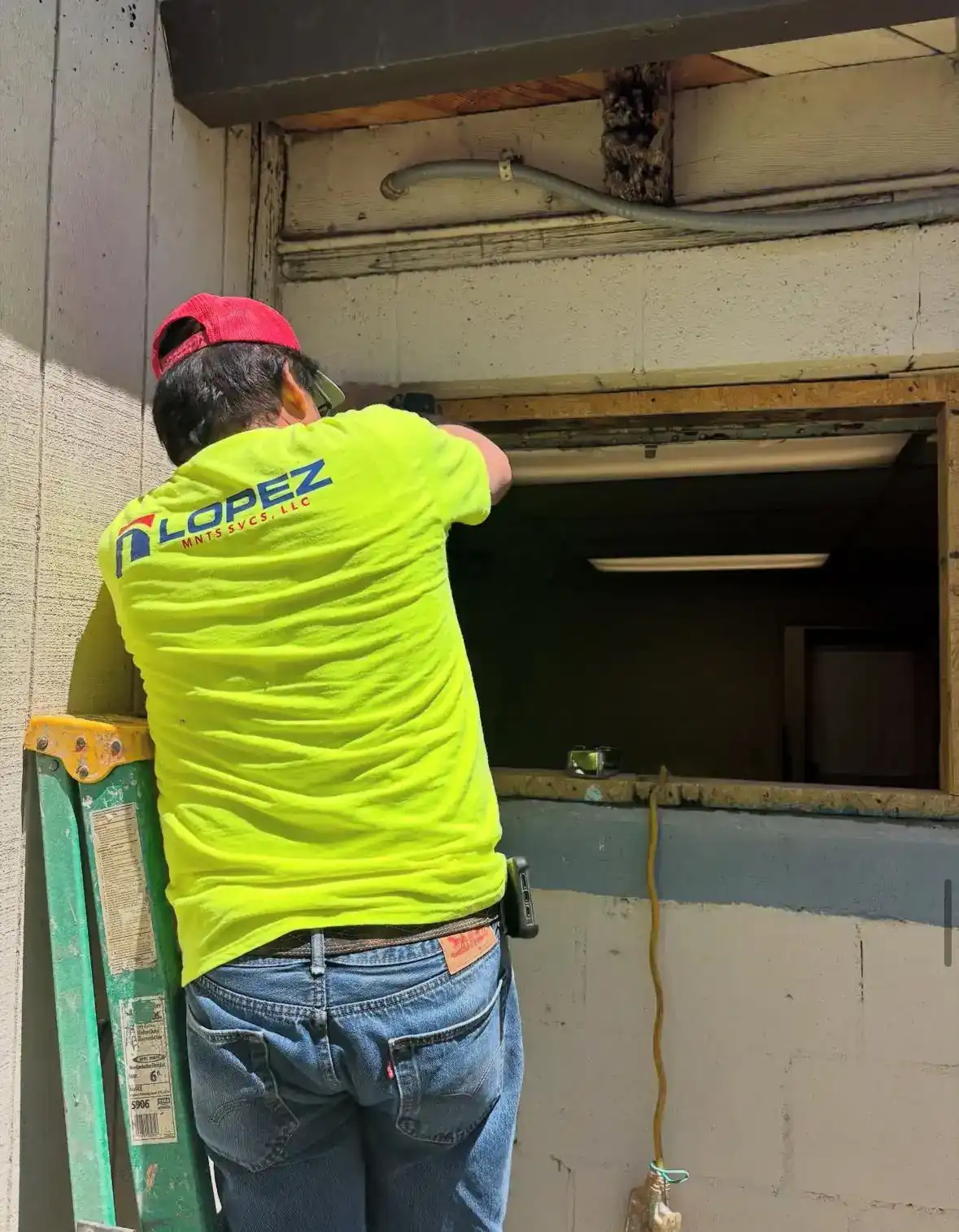 Lopez carpenter framing out an opening inside a building