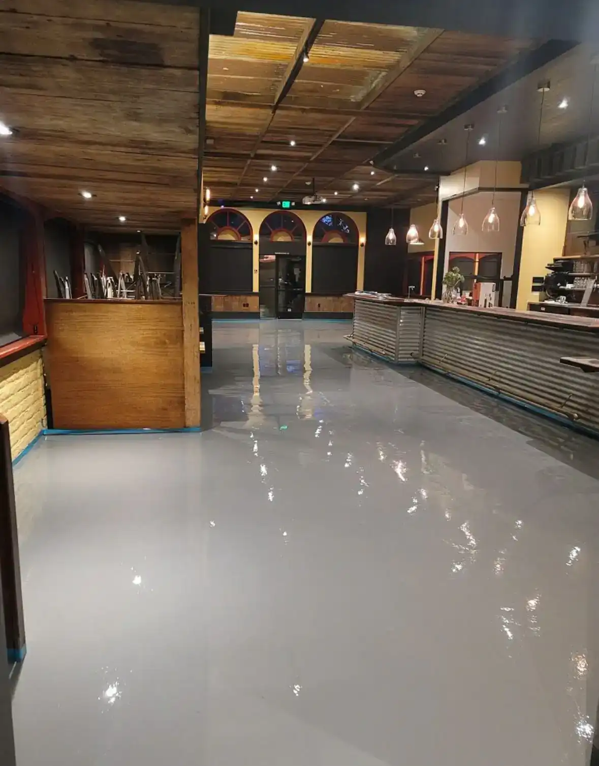 Finished restaurant interior with sealed concrete floor and new bar