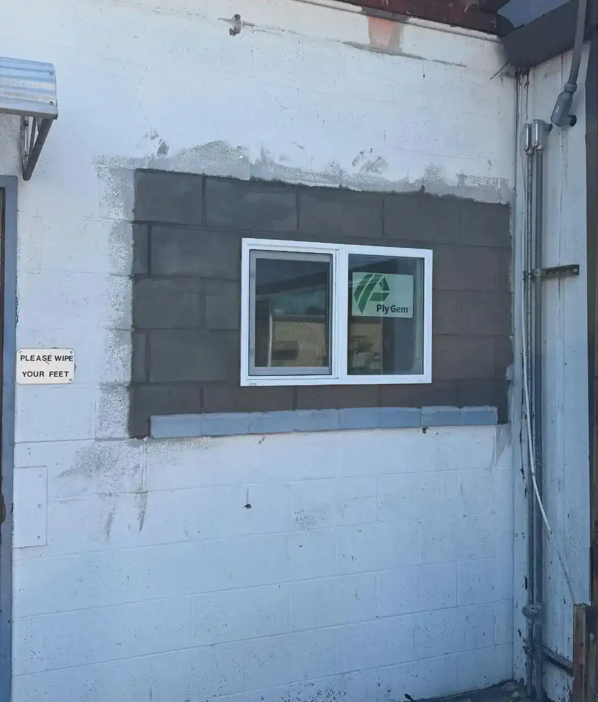 New window framed into a block wall during a building renovation